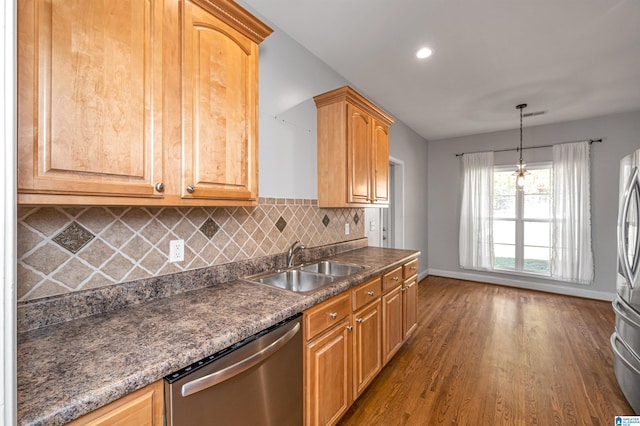 kitchen with sink, hanging light fixtures, dark wood-type flooring, stainless steel appliances, and backsplash