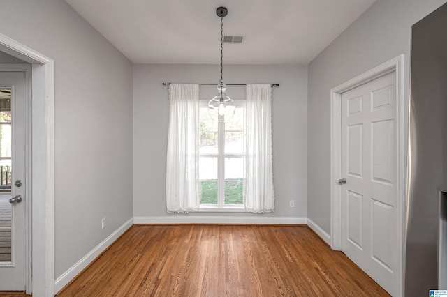 unfurnished dining area featuring hardwood / wood-style floors