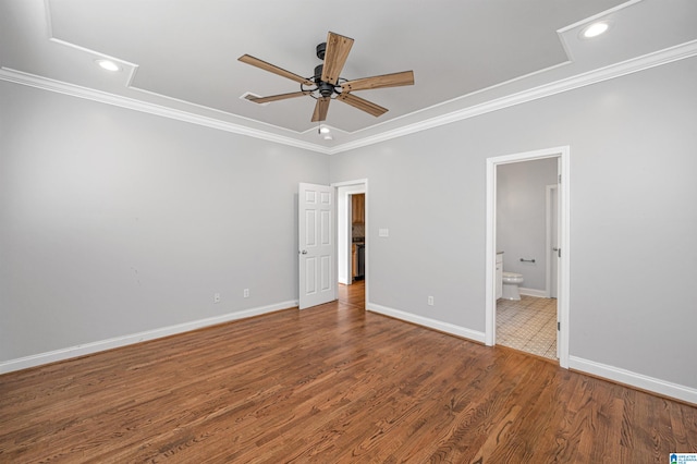 unfurnished bedroom featuring wood-type flooring, ensuite bath, ceiling fan, and ornamental molding