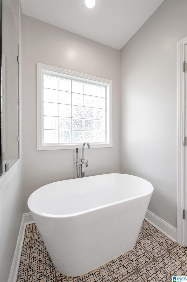 99 Pats Way, Springville, AL 35146 - full bathroom with baseboards, plenty of natural light, and a soaking tub