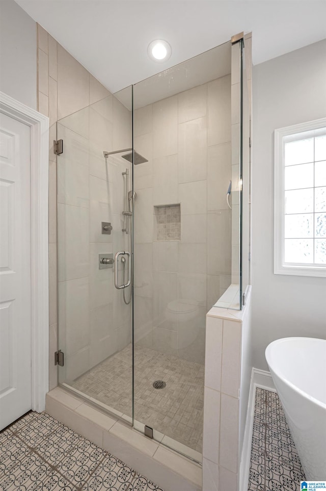 bathroom with tile patterned floors and separate shower and tub