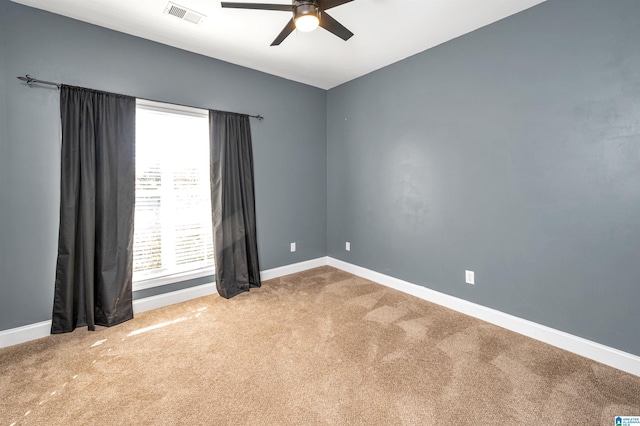 spare room featuring carpet flooring and ceiling fan