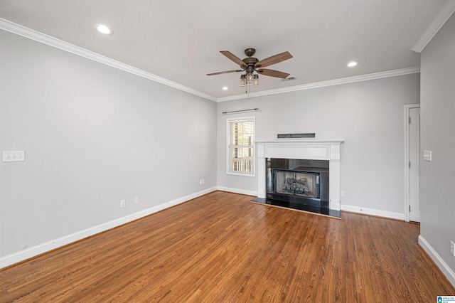 unfurnished living room with hardwood / wood-style flooring, ceiling fan, and crown molding