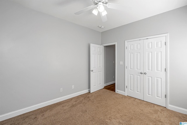 unfurnished bedroom featuring ceiling fan, carpet floors, and a closet