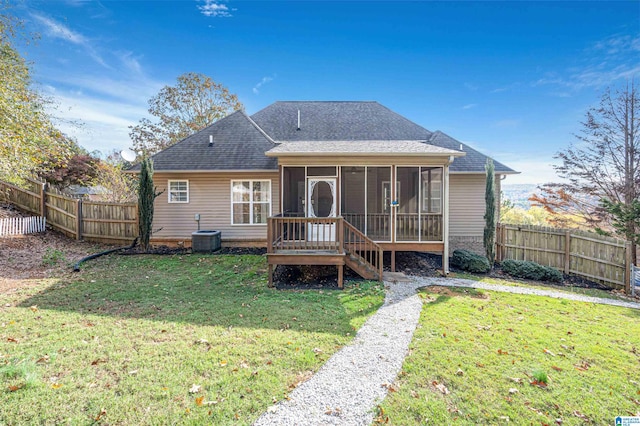 back of house with a sunroom, a yard, and cooling unit