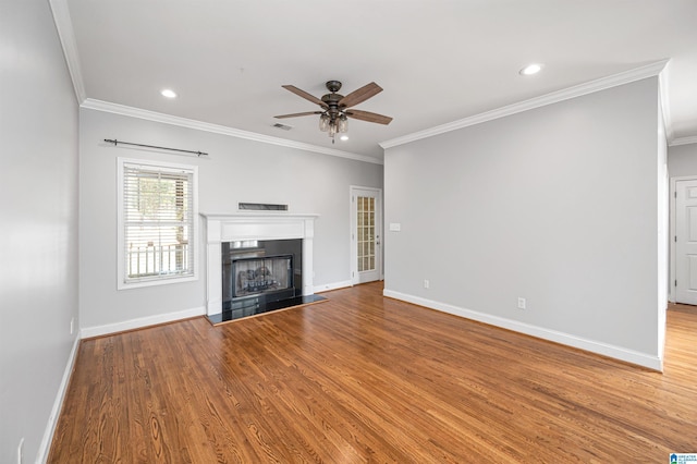 99 Pats Way, Springville, AL 35146 - unfurnished living room with a ceiling fan, crown molding, baseboards, a fireplace with raised hearth, and wood finished floors