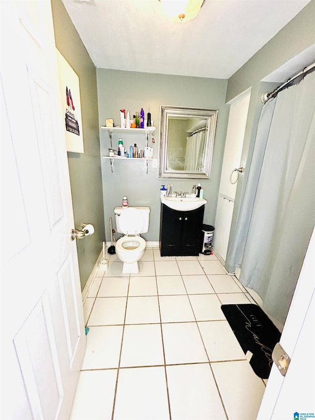 bathroom featuring tile patterned floors, vanity, and toilet