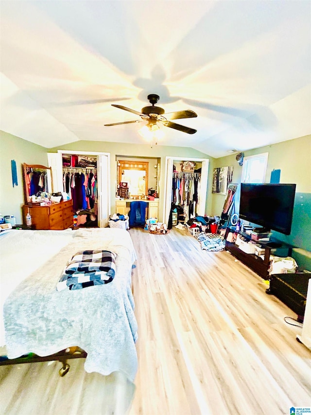 bedroom with ceiling fan, hardwood / wood-style floors, and lofted ceiling