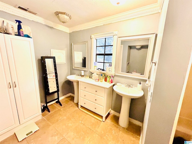 bathroom featuring tile patterned flooring, sink, and crown molding