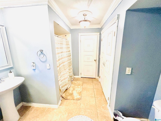 bathroom with tile patterned floors and ornamental molding