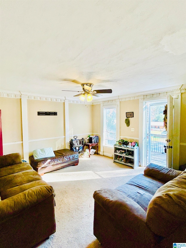 living room featuring carpet flooring, a wealth of natural light, and ceiling fan