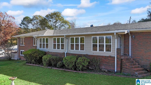 view of side of property featuring a yard