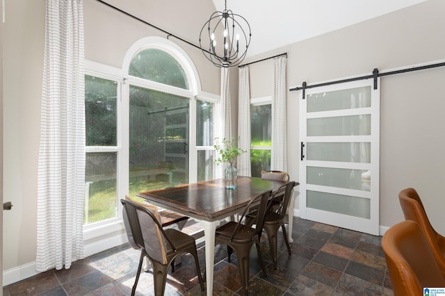 dining room with a barn door and a notable chandelier