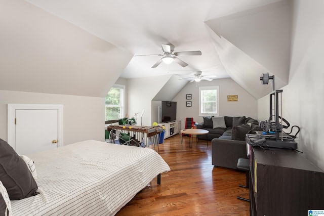 bedroom with dark hardwood / wood-style floors, vaulted ceiling, and ceiling fan