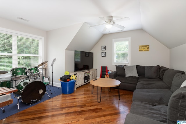 living room featuring dark hardwood / wood-style floors, vaulted ceiling, and ceiling fan