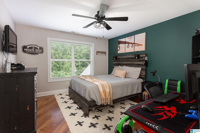 bedroom featuring ceiling fan and dark hardwood / wood-style floors