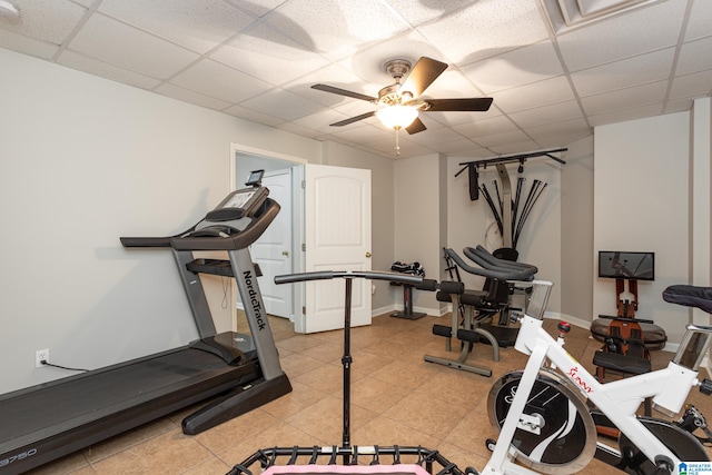 workout area with a paneled ceiling and ceiling fan