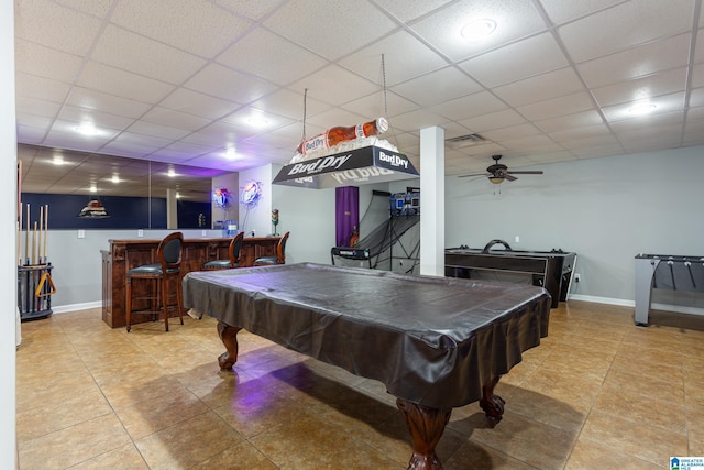 rec room featuring a paneled ceiling, tile patterned floors, ceiling fan, bar, and pool table