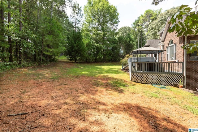 view of yard with a gazebo and a wooden deck