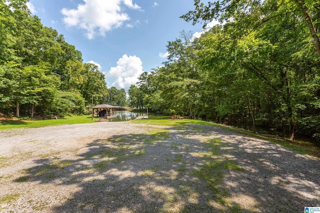 view of yard featuring a gazebo and a water view