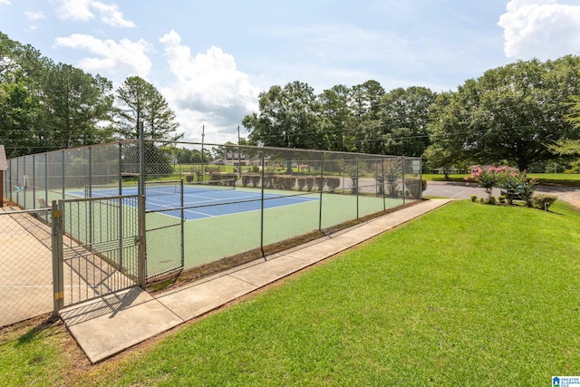 view of sport court with a yard