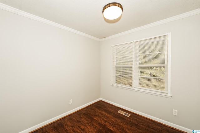 unfurnished room featuring hardwood / wood-style floors and crown molding