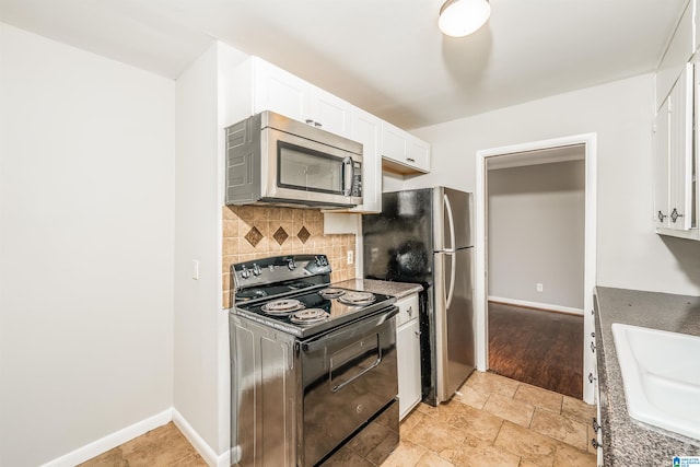 kitchen with white cabinets, decorative backsplash, sink, and stainless steel appliances