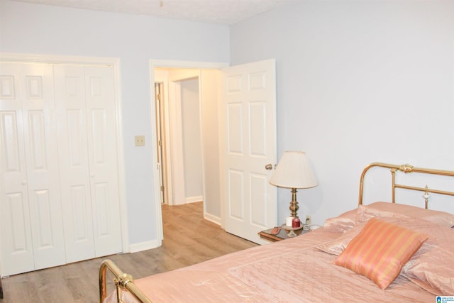 bedroom featuring a closet and light wood-type flooring