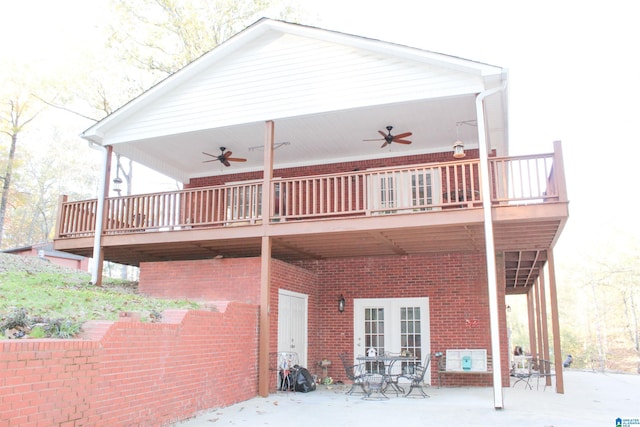 back of house with french doors, ceiling fan, a wooden deck, and a patio