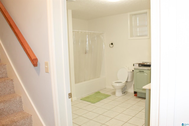 bathroom featuring tile patterned flooring, shower / tub combo, and toilet