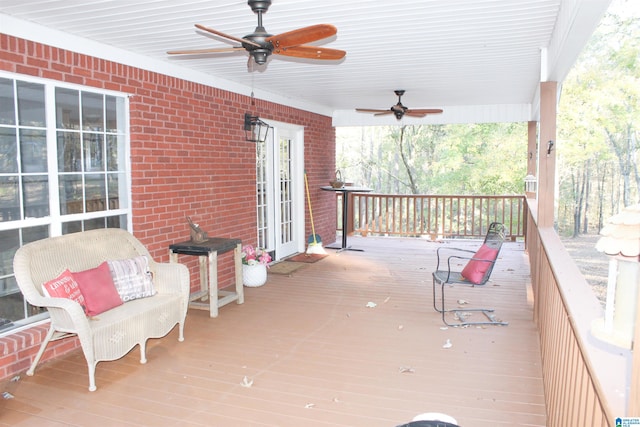 wooden deck with ceiling fan and a porch