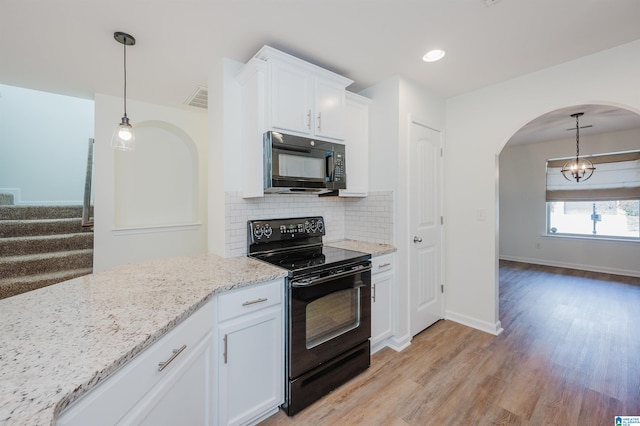 kitchen with black appliances, light wood-type flooring, tasteful backsplash, light stone counters, and white cabinetry