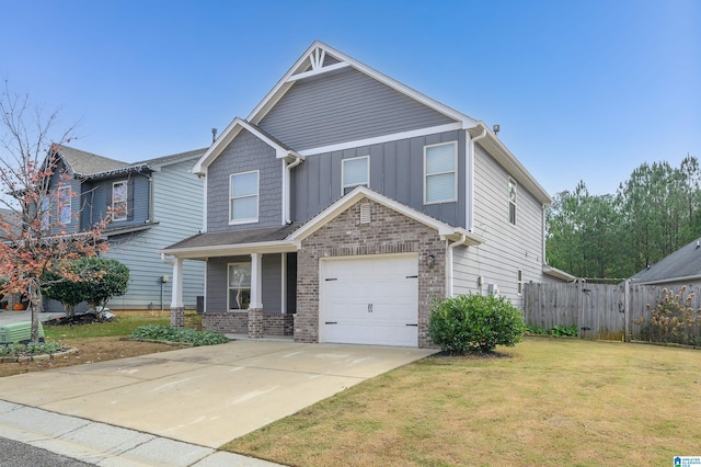 craftsman house featuring a front lawn and a garage