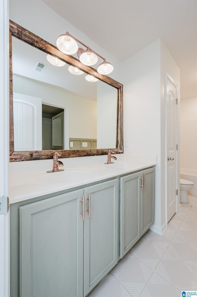 bathroom featuring vanity and toilet