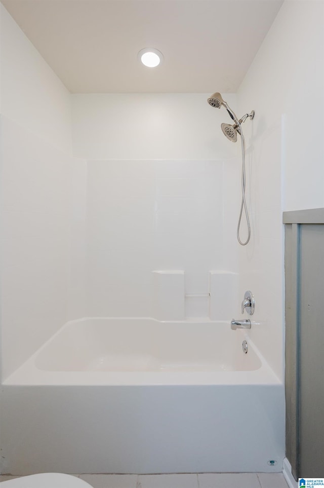 bathroom with shower / tub combination, tile patterned flooring, and toilet