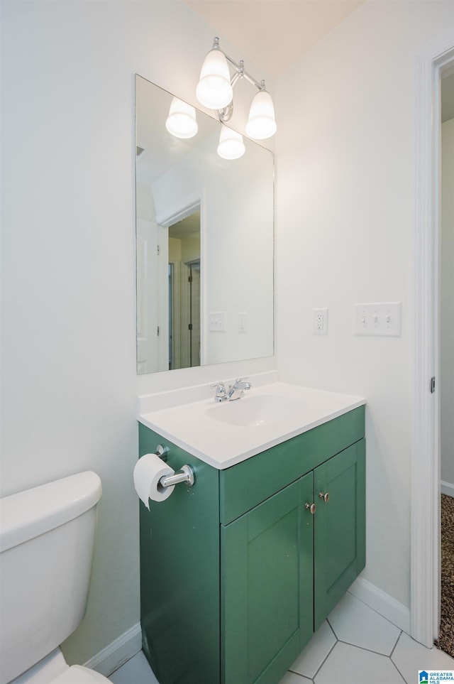 bathroom featuring tile patterned flooring, vanity, and toilet