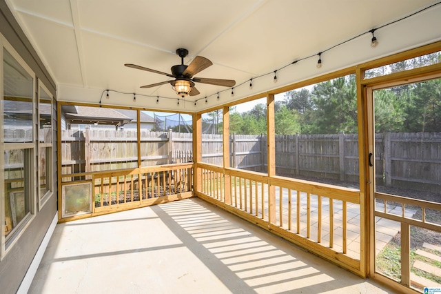 unfurnished sunroom with a wealth of natural light and ceiling fan