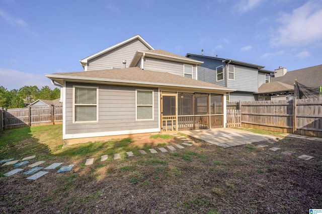 rear view of property with a patio and a sunroom