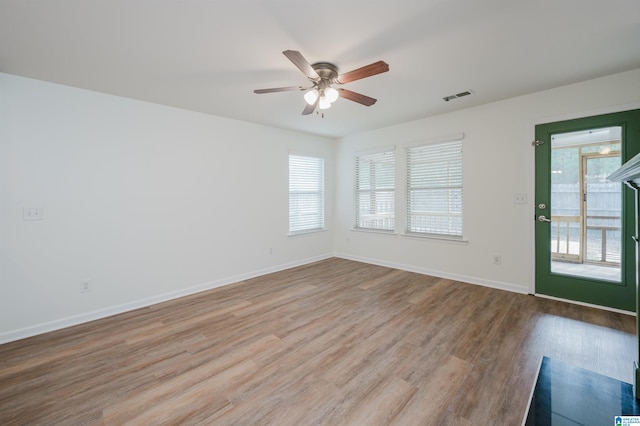 spare room with ceiling fan, plenty of natural light, and light hardwood / wood-style floors