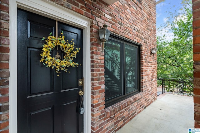 view of exterior entry featuring covered porch