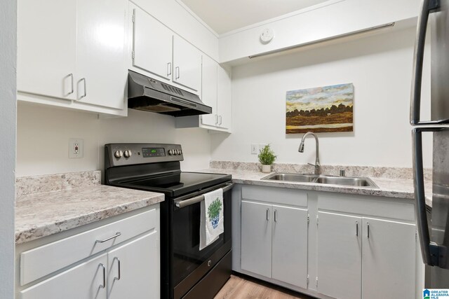 kitchen with white cabinets, stainless steel appliances, light hardwood / wood-style flooring, and sink