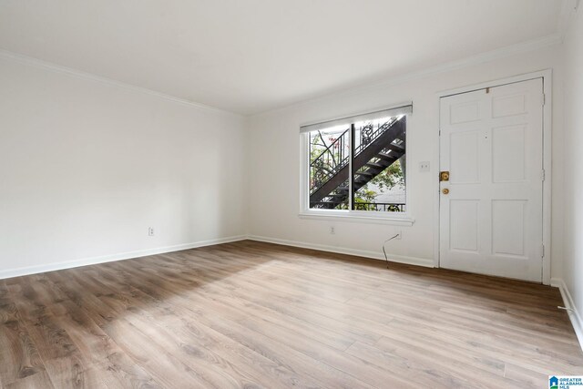 foyer featuring crown molding and light wood-type flooring