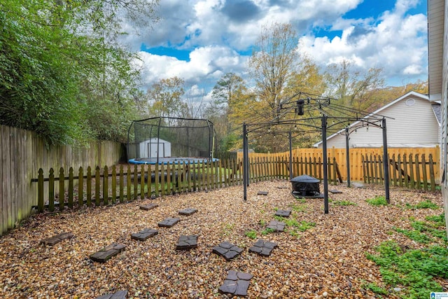 view of yard featuring a gazebo and a trampoline