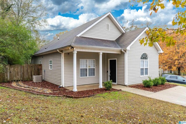 view of front property featuring a front lawn and central AC unit