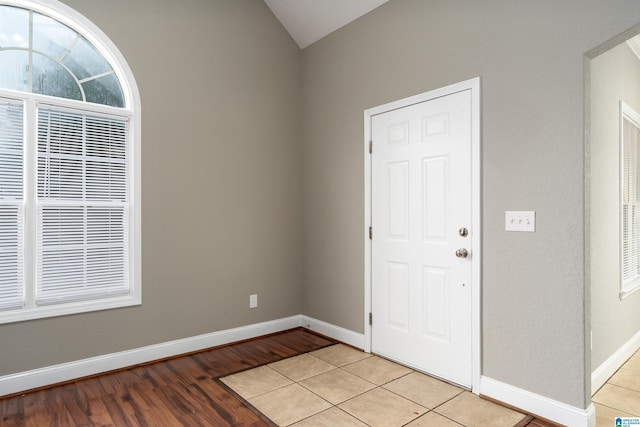 entrance foyer with light hardwood / wood-style flooring and lofted ceiling