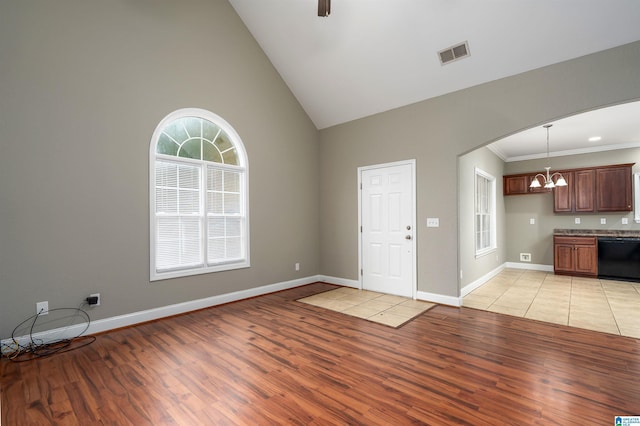 entrance foyer featuring crown molding, high vaulted ceiling, light hardwood / wood-style floors, and ceiling fan with notable chandelier