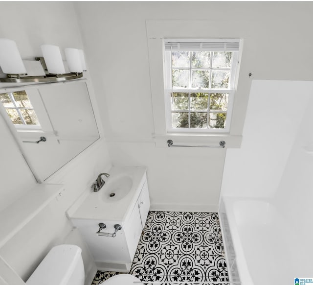 bathroom with vanity and a tub