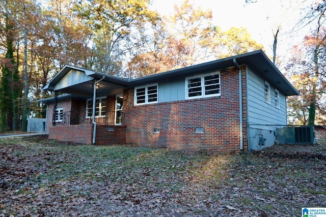 view of front of house with covered porch and central air condition unit