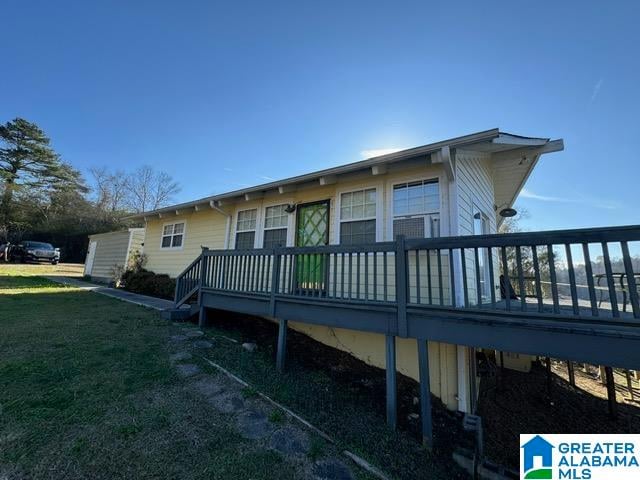 exterior space featuring a wooden deck and a yard