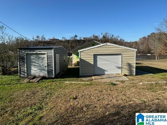 view of outdoor structure with a garage and a yard